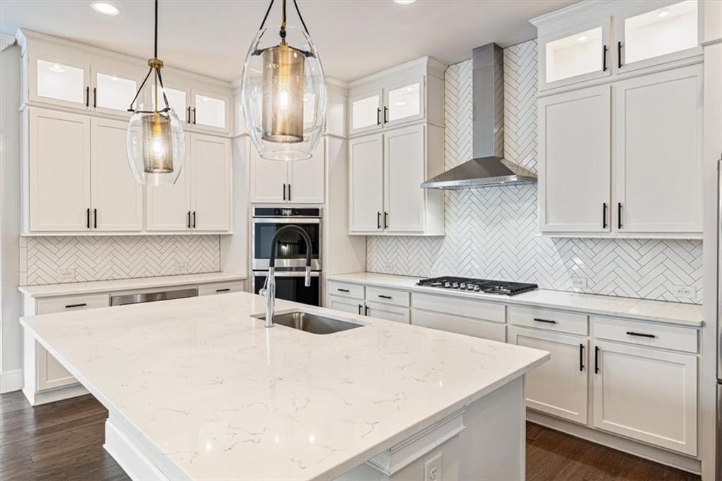 947 Hunter Way Milton, GA 30004 - Photo 32 of 78 a kitchen with white cabinets and appliances