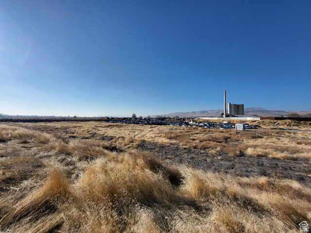View of local wilderness featuring a mountain backdrop and rural landscape