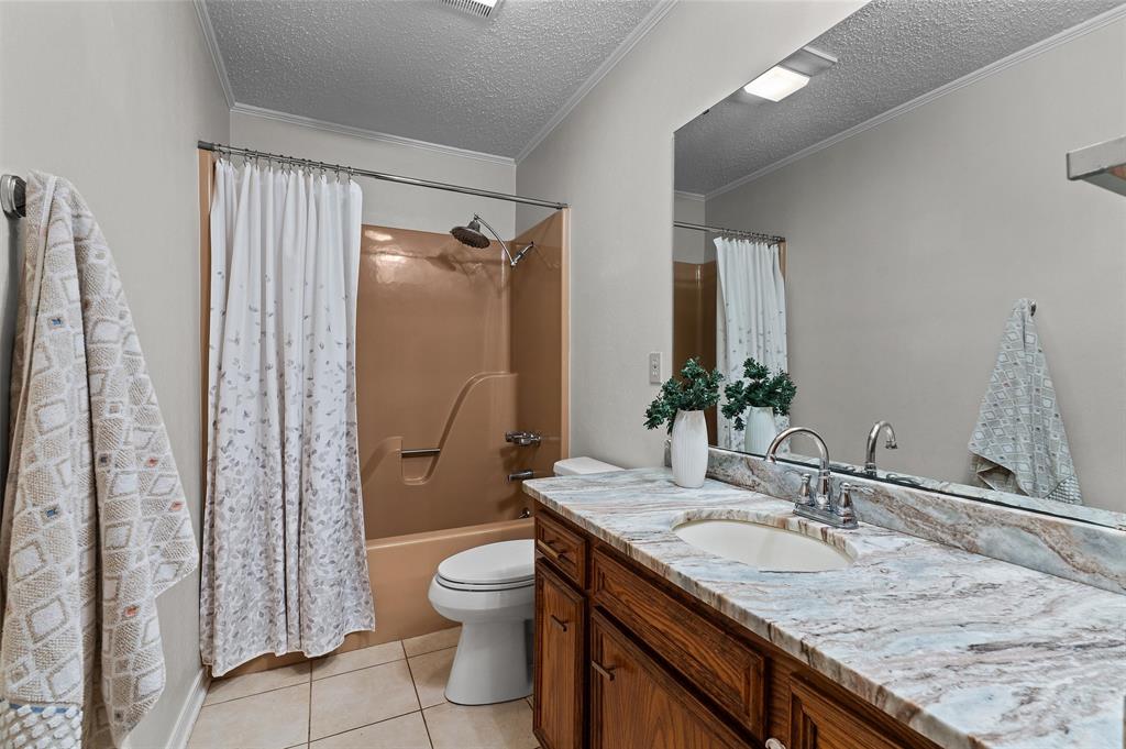 927 Stonewall-Preston Road Stonewall, LA 71078 - Photo 23 of 28 a bathroom with a granite countertop sink toilet and shower