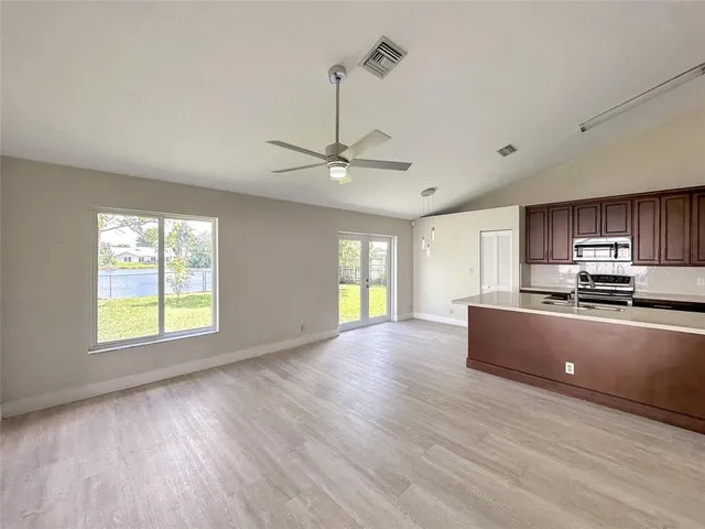 a view of a kitchen with furniture wooden floor and window