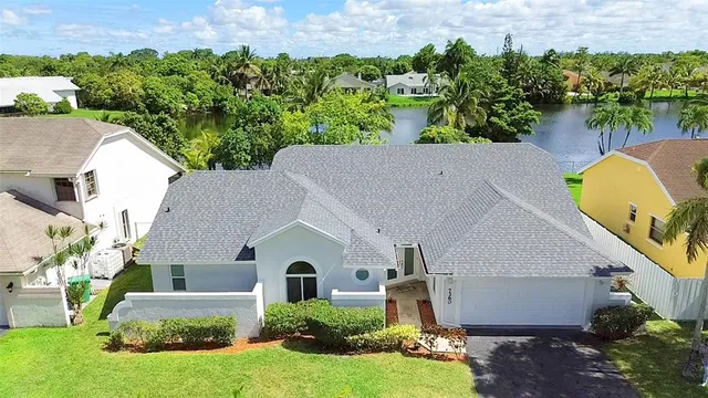 a aerial view of a house with a yard and plants