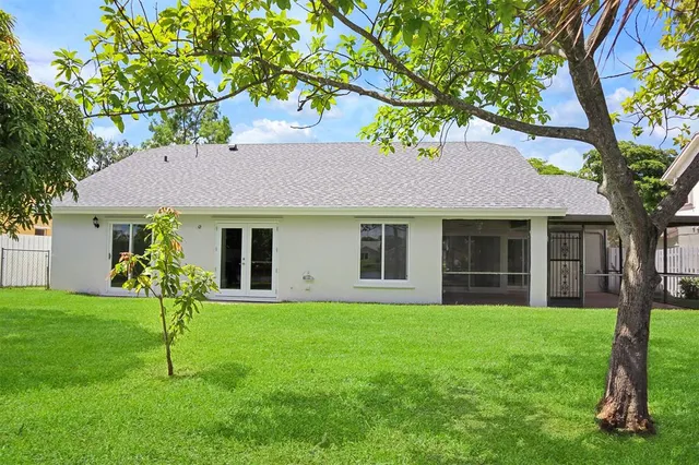 a front view of a house with a yard and trees