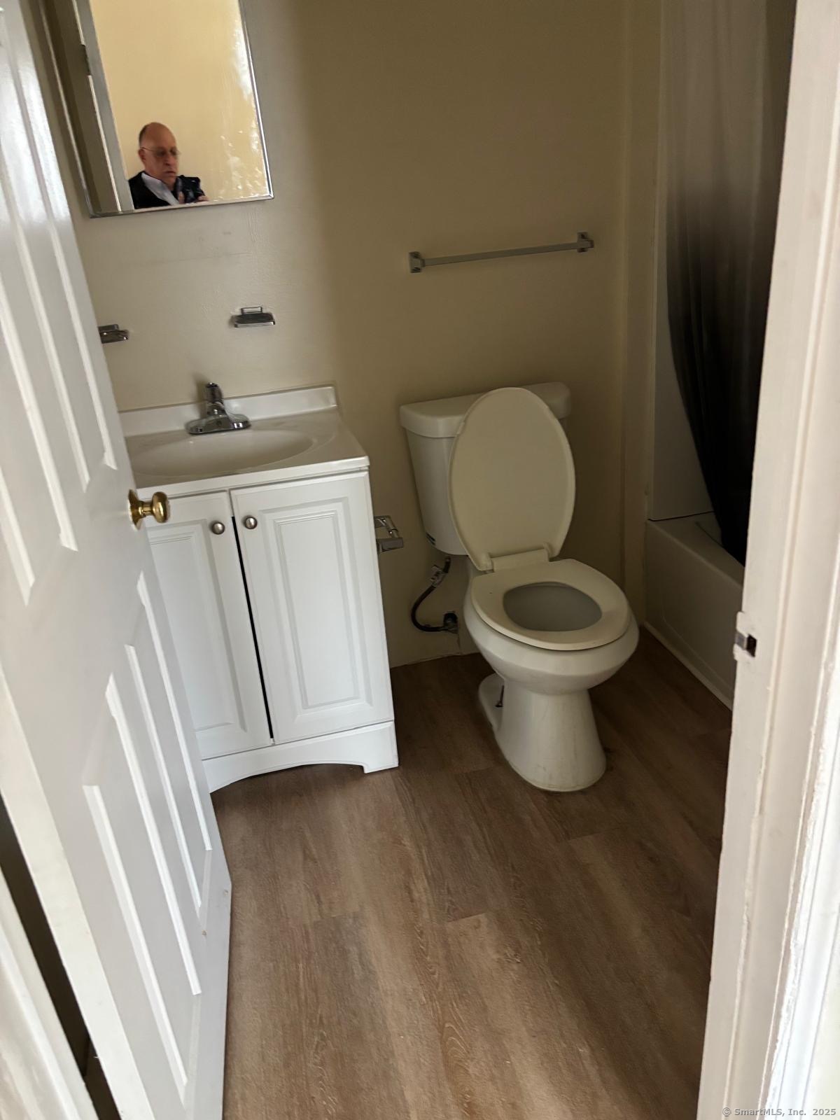 1057 East Main Street Bridgeport, CT 06608 - Photo 4 of 9 a white toilet sitting next to a sink