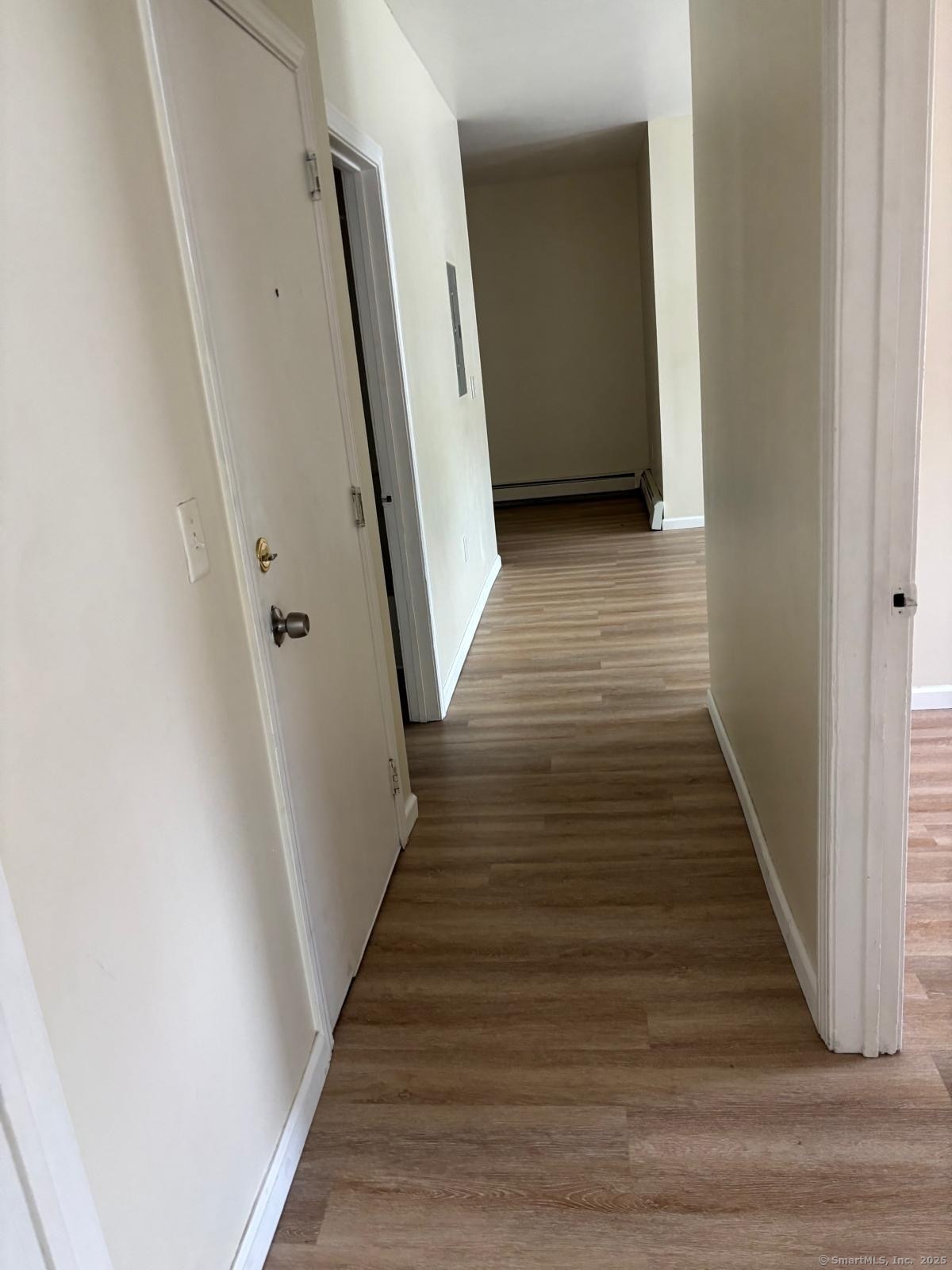 1057 East Main Street Bridgeport, CT 06608 - Photo 6 of 9 a view of a hallway with wooden floor and staircase