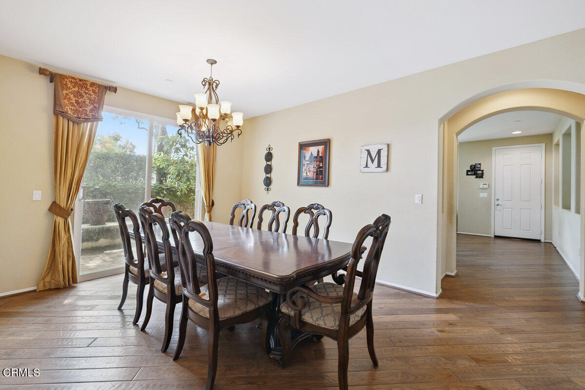 3401 Aviara Lane Oxnard, CA 93036 - Photo 12 of 55 a view of a dining room with furniture wooden floor and chandelier