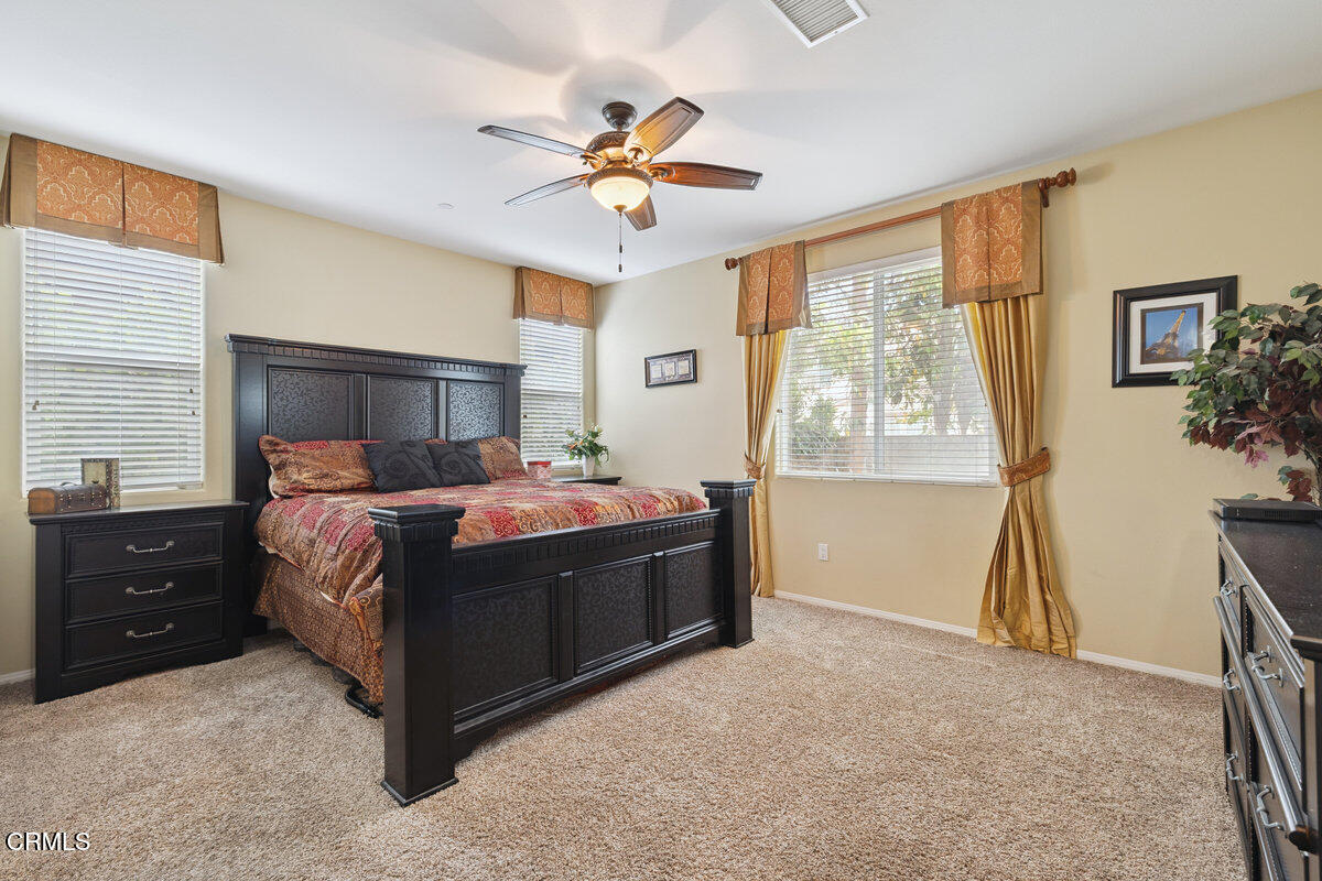 3401 Aviara Lane Oxnard, CA 93036 - Photo 17 of 55 a bedroom with a bed and a chandelier