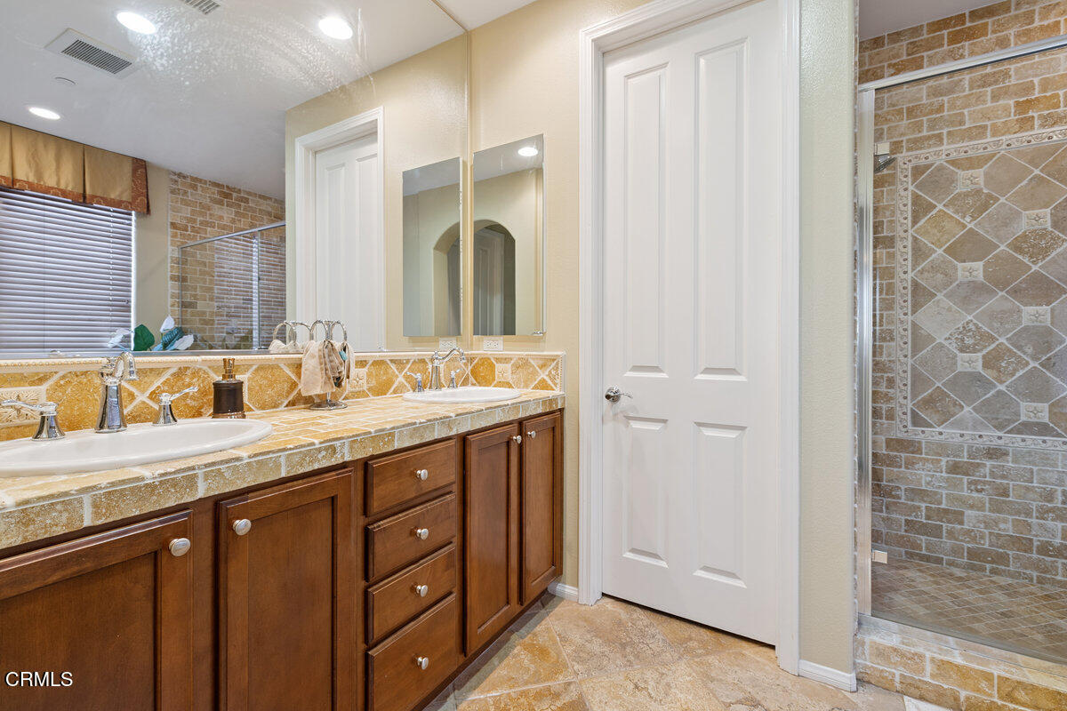 3401 Aviara Lane Oxnard, CA 93036 - Photo 19 of 55 a bathroom with a granite countertop sink and a mirror