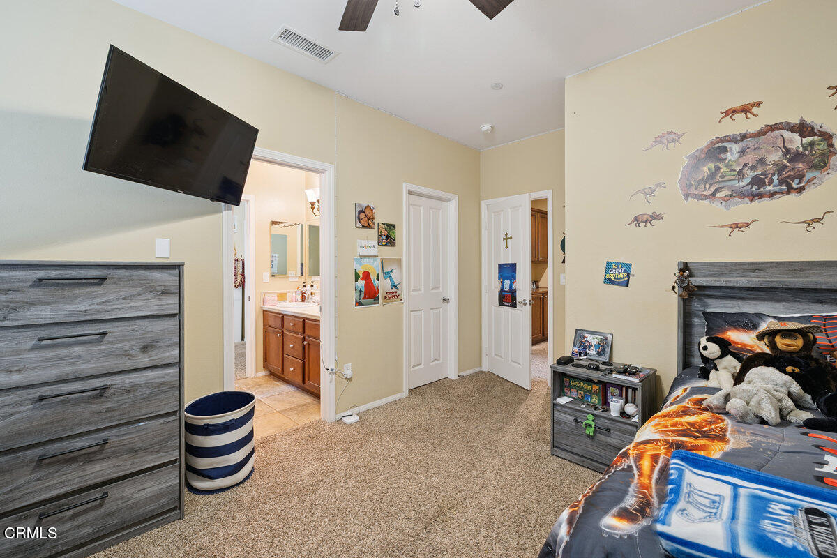 3401 Aviara Lane Oxnard, CA 93036 - Photo 25 of 55 a bedroom with a bed and a flat screen tv