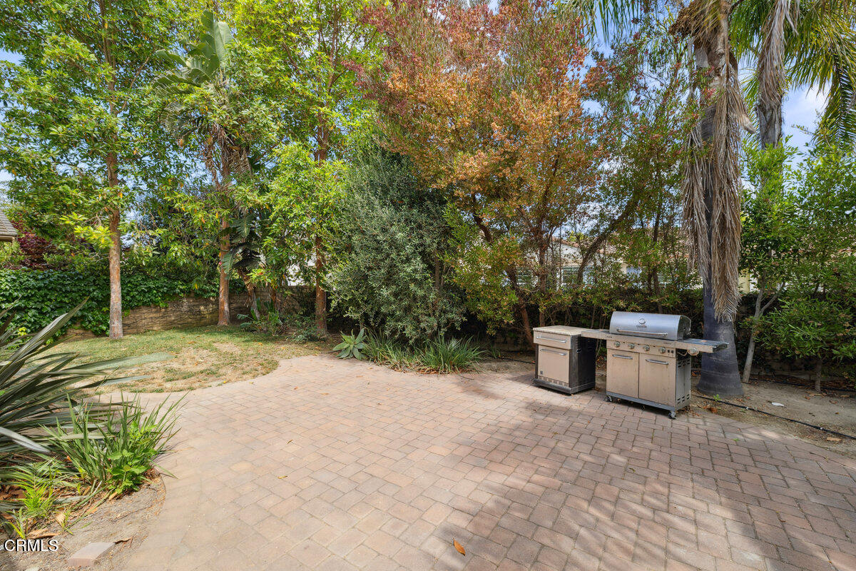 3401 Aviara Lane Oxnard, CA 93036 - Photo 40 of 55 a view of a backyard with potted plants and large trees