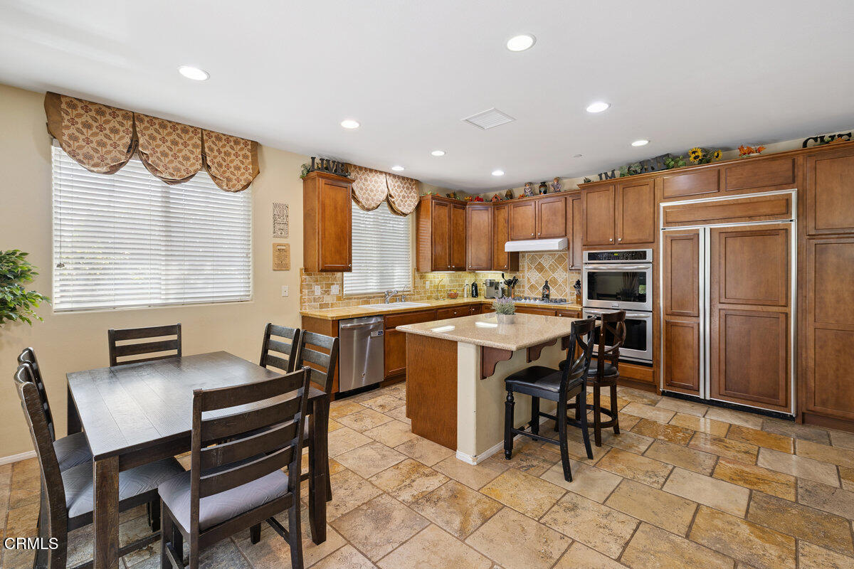 3401 Aviara Lane Oxnard, CA 93036 - Photo 4 of 55 a kitchen with a dining table chairs and refrigerator