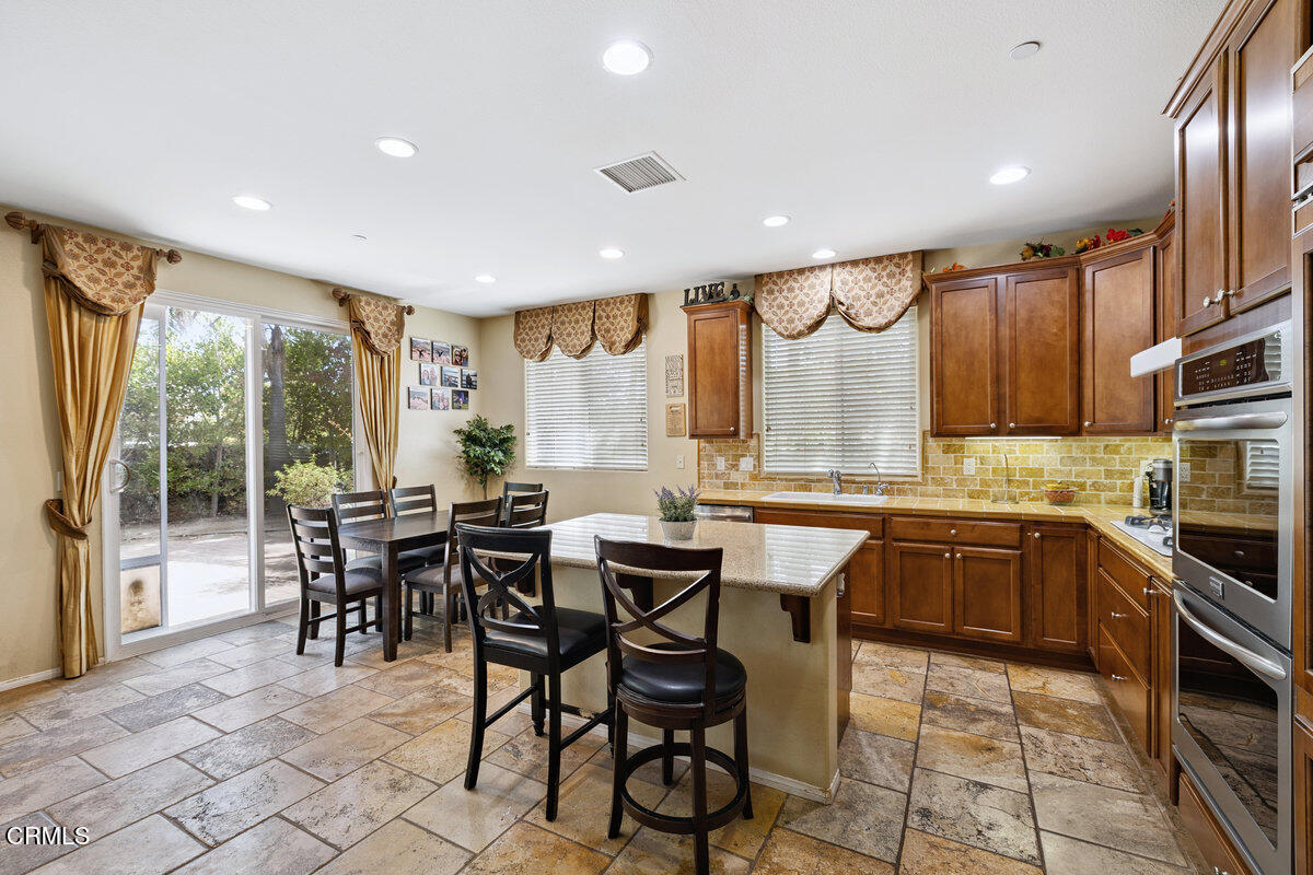 3401 Aviara Lane Oxnard, CA 93036 - Photo 5 of 55 a kitchen with a table chairs sink and cabinets