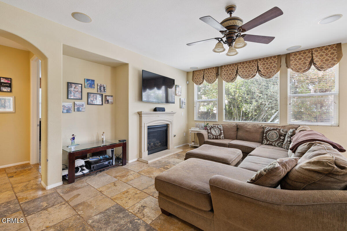 3401 Aviara Lane Oxnard, CA 93036 - Photo 8 of 55 a living room with furniture a fireplace and a large window