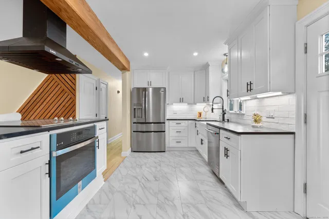 a kitchen with appliances cabinets and a sink