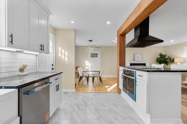 a kitchen with stainless steel appliances granite countertop a sink and a stove