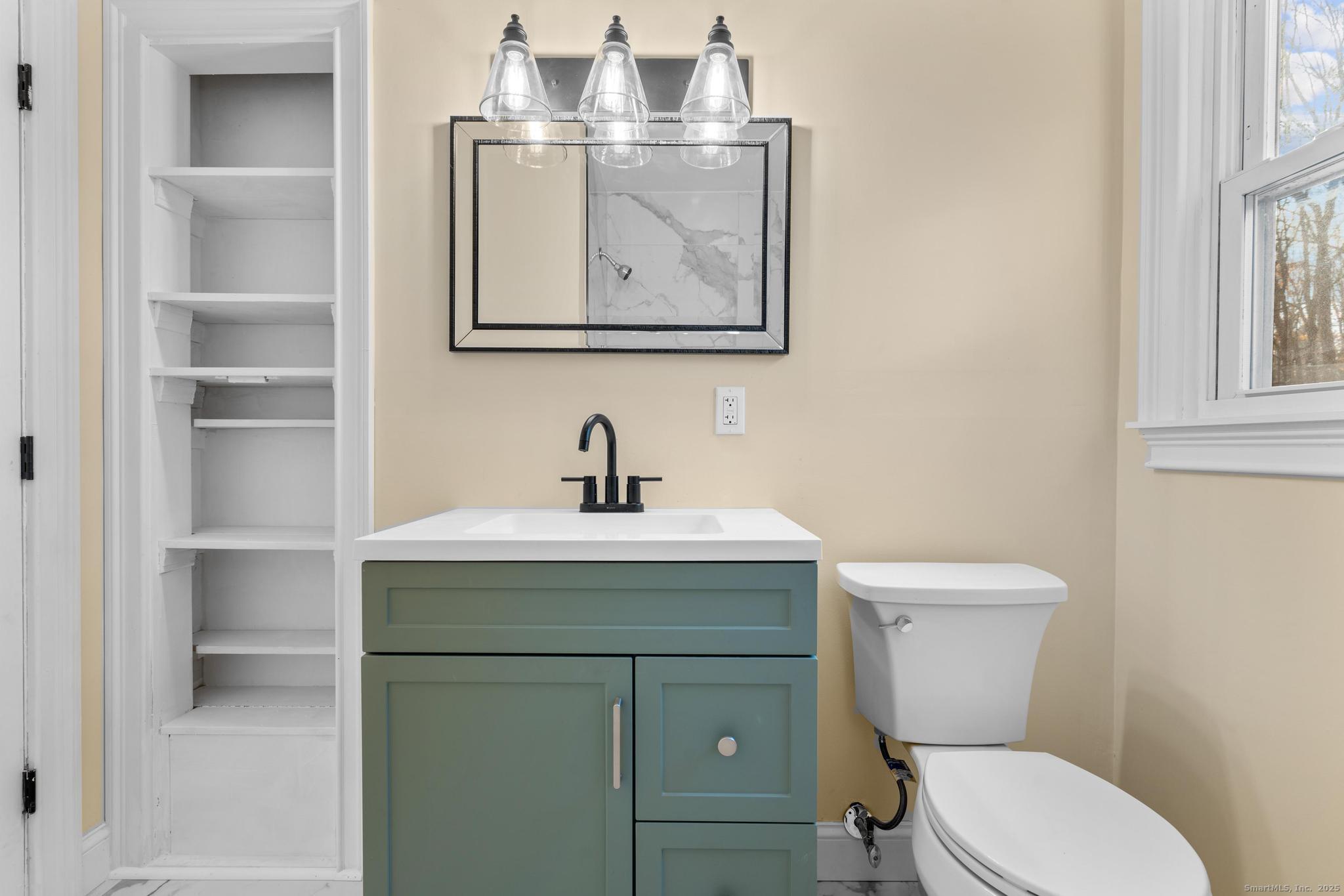 24 Evergreen Road North Branford, CT 06472 - Photo 14 of 31 a bathroom with a toilet sink and mirror