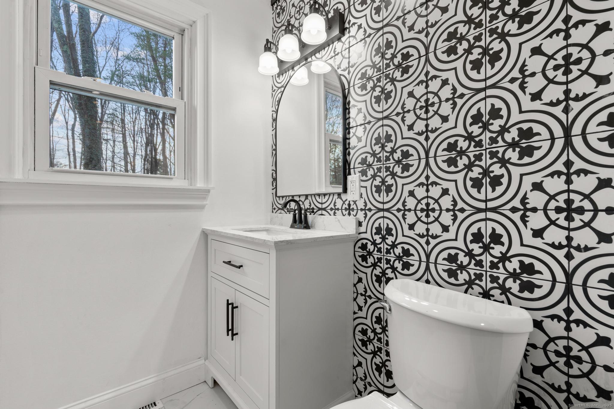 24 Evergreen Road North Branford, CT 06472 - Photo 16 of 31 a bathroom with a sink a toilet and a mirror