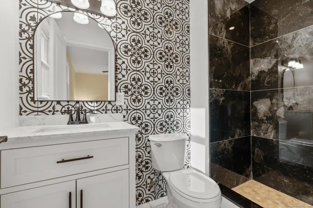 a bathroom with a sink toilet and shower