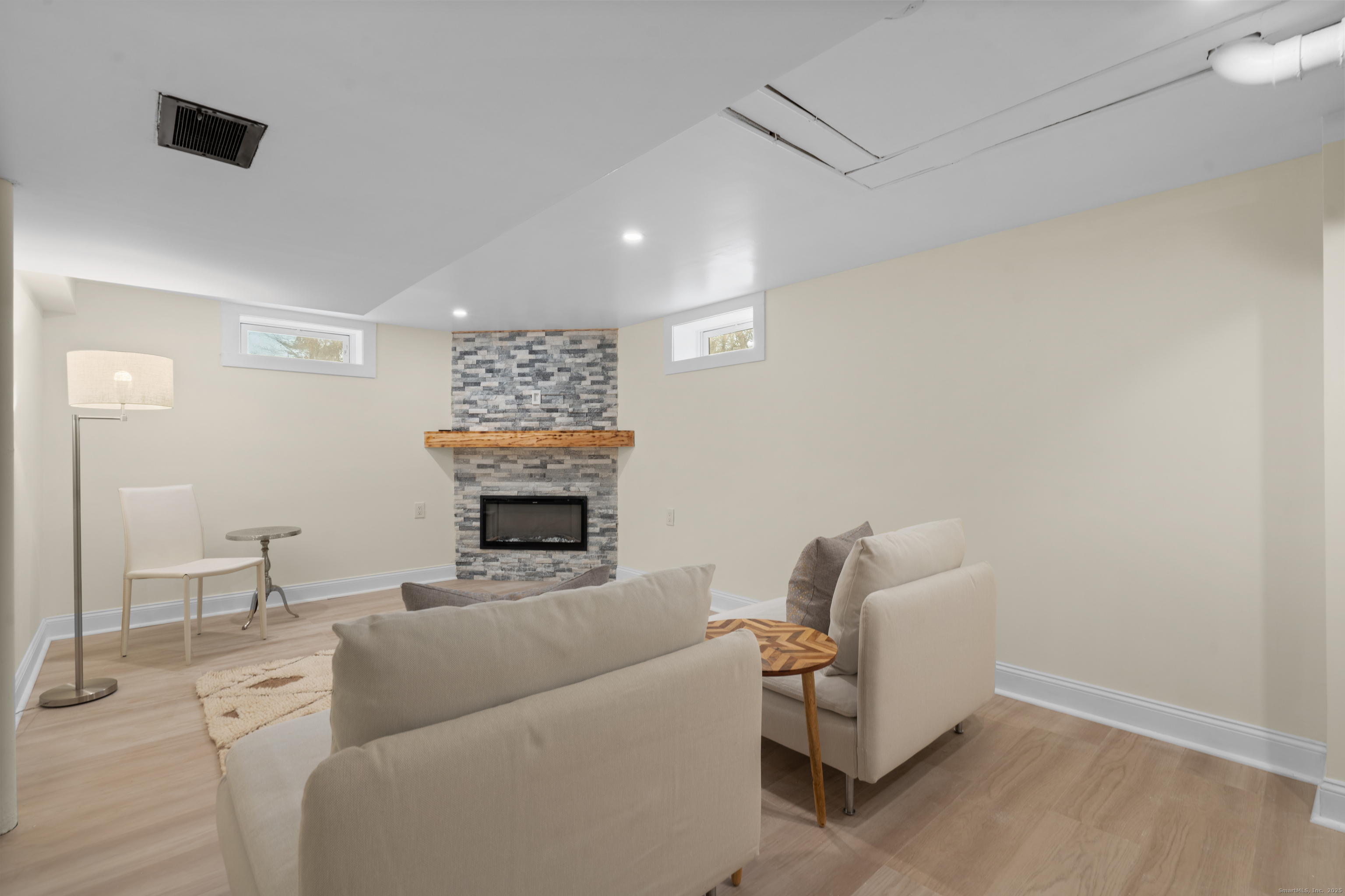 24 Evergreen Road North Branford, CT 06472 - Photo 18 of 31 a living room with furniture a fireplace and a mirror