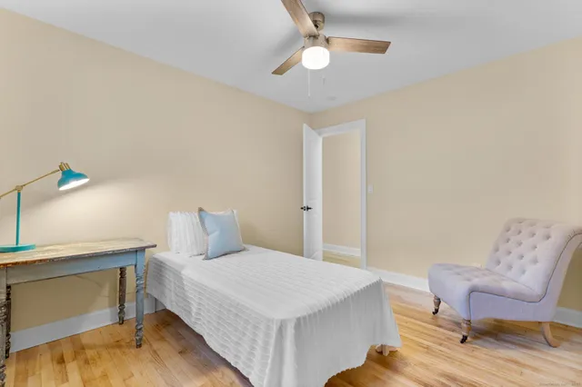 a bedroom with a bed and a chair