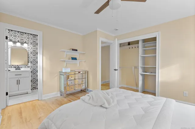 a bedroom with a bed and a view of kitchen