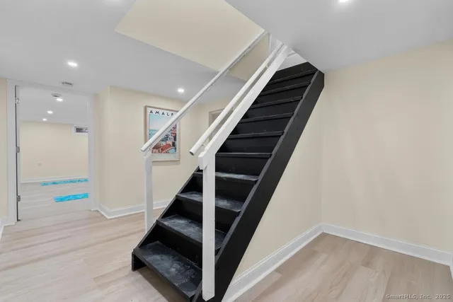 a view of entryway and hall with wooden floor