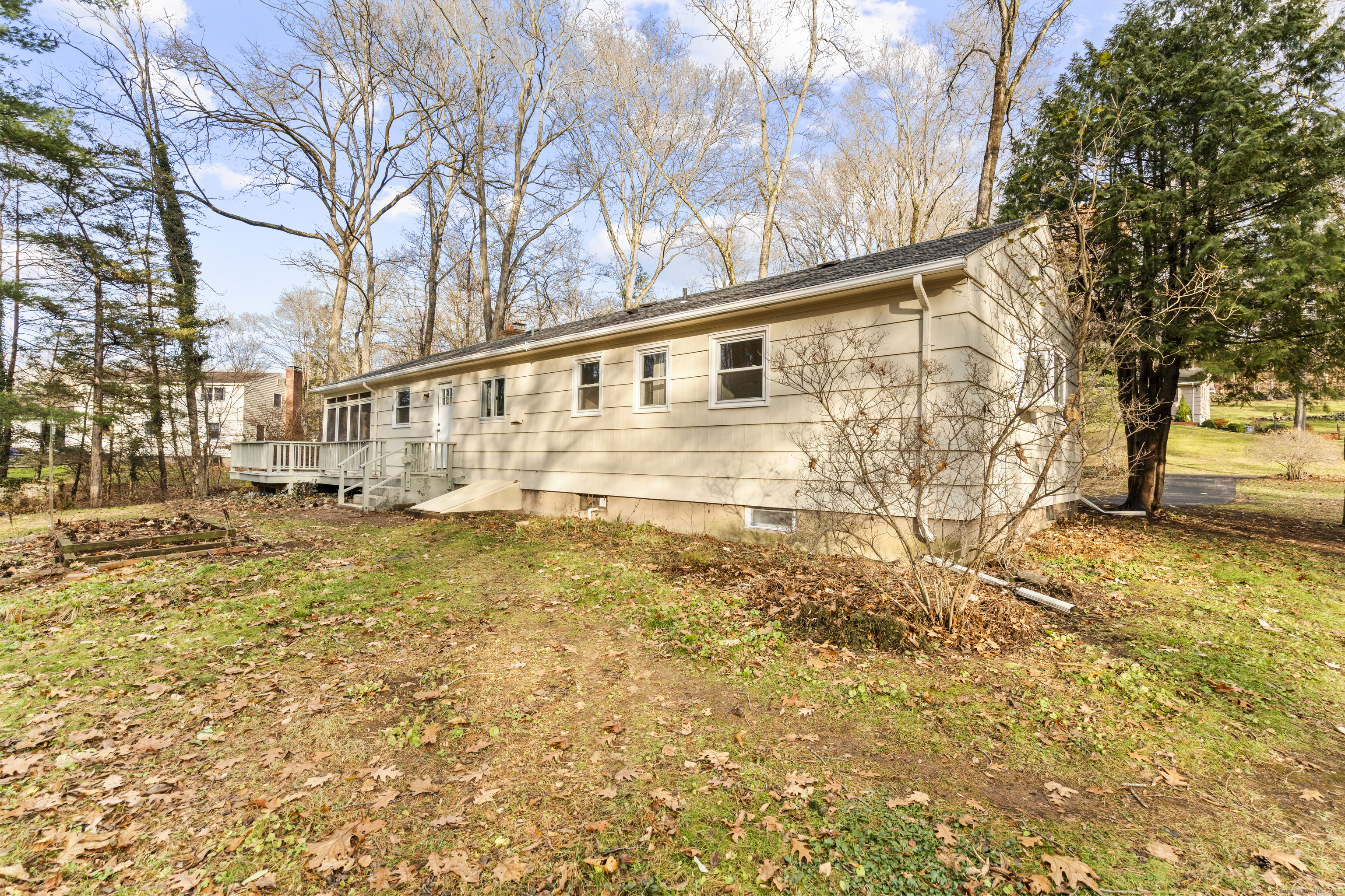 24 Evergreen Road North Branford, CT 06472 - Photo 28 of 31 a backyard of a house with large trees and outdoor seating