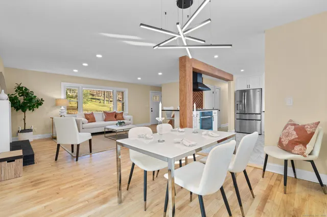 a view of a dining room with furniture window and wooden floor
