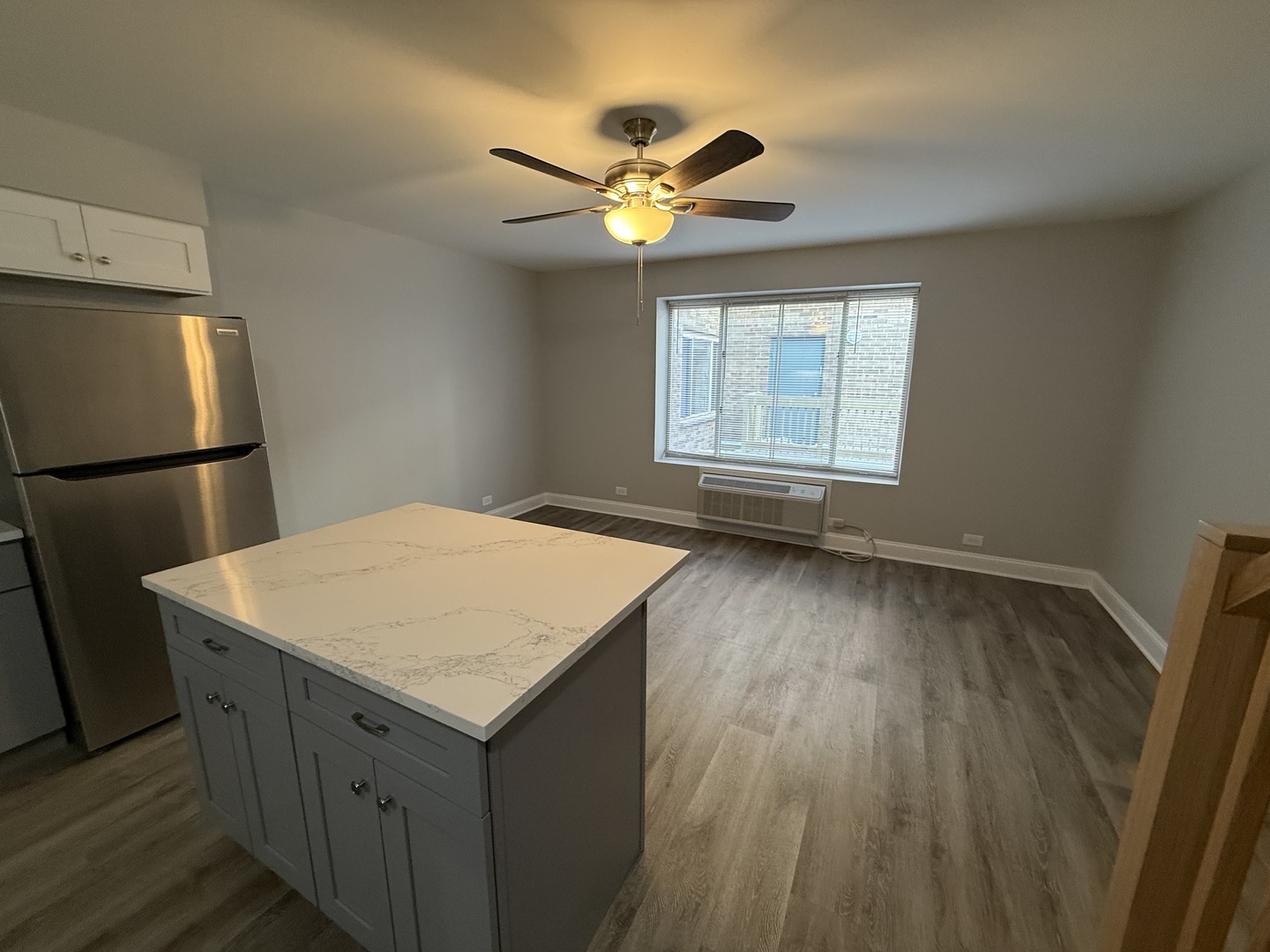 744 West Gordon Terrace, Unit 311 Chicago, IL 60613 - Photo 3 of 9 a kitchen with a wooden floor and window