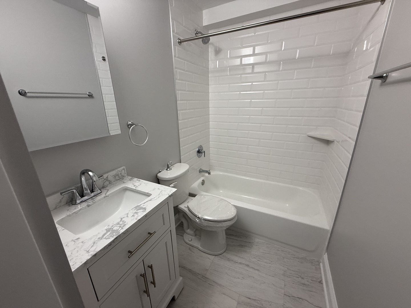 744 West Gordon Terrace, Unit 311 Chicago, IL 60613 - Photo 9 of 9 a bathroom with a sink a toilet and shower