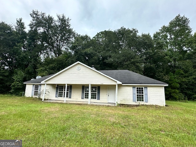 7358 Stilson-Leefield Road Brooklet, GA 30415 - Photo 1 of 1 a white house sitting in the middle of a field