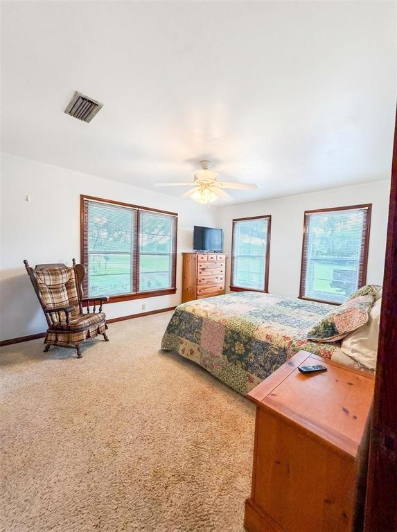 1925 Highway 527 Elm Grove, LA 71051 - Photo 12 of 15 a bed sitting in a spacious bedroom next to a window