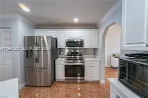 a view of kitchen with furniture and refrigerator
