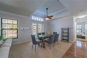 a view of a dining room with furniture and a chandelier