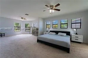 a living room with furniture and a ceiling fan