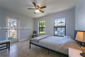 1063 Mayford Lake Road Moore Haven, FL 33471 - Photo 19 of 39 a bedroom with a large bed and a window
