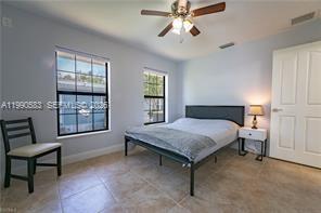 1063 Mayford Lake Road Moore Haven, FL 33471 - Photo 23 of 39 a bedroom that has a bed and chair