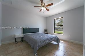 1063 Mayford Lake Road Moore Haven, FL 33471 - Photo 25 of 39 a bed sitting in a bedroom next to a window