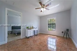 a bedroom with bed and a window