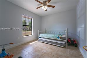 1063 Mayford Lake Road Moore Haven, FL 33471 - Photo 27 of 39 a bedroom with bed and a window