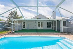 1063 Mayford Lake Road Moore Haven, FL 33471 - Photo 31 of 39 a view of a white house with a swimming pool