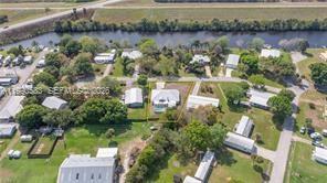 1063 Mayford Lake Road Moore Haven, FL 33471 - Photo 37 of 39 an aerial view of residential houses with outdoor space and lake view