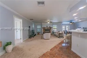 a room with lots of table chair and couches