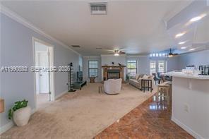 1063 Mayford Lake Road Moore Haven, FL 33471 - Photo 4 of 39 a room with lots of table chair and couches