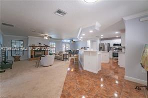 1063 Mayford Lake Road Moore Haven, FL 33471 - Photo 5 of 39 a view of a living room and kitchen