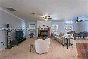 1063 Mayford Lake Road Moore Haven, FL 33471 - Photo 7 of 39 a living room with furniture a fireplace and a chandelier