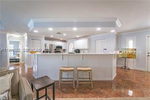 1063 Mayford Lake Road Moore Haven, FL 33471 - Photo 10 of 39 a open kitchen with kitchen island a sink table and chairs