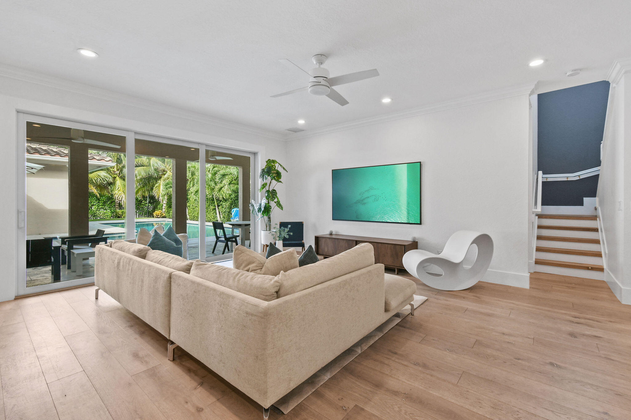 158 Ennis Lane Jupiter, FL 33458 - Photo 12 of 77 a living room with furniture a flat screen tv and floor to ceiling window