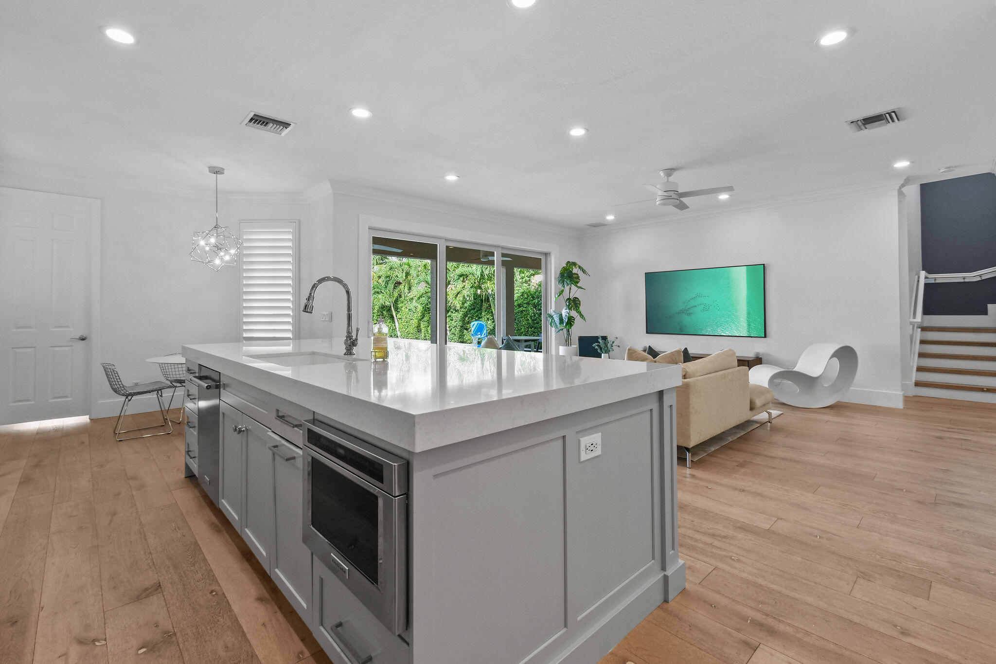 158 Ennis Lane Jupiter, FL 33458 - Photo 22 of 77 a kitchen with stainless steel appliances granite countertop sink stove and wooden floor