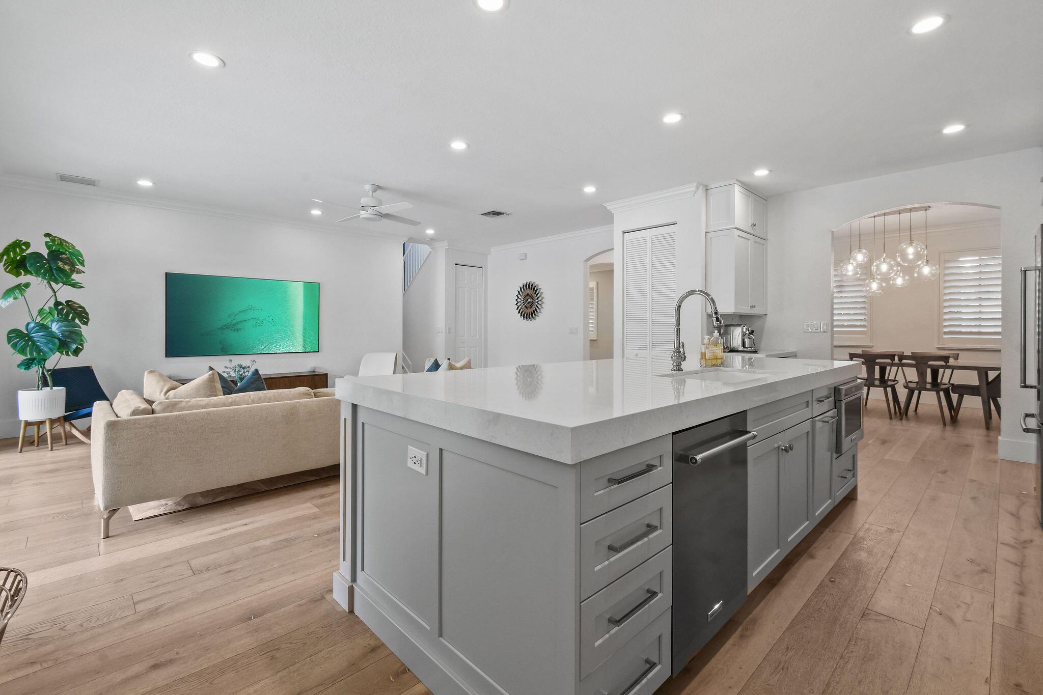 158 Ennis Lane Jupiter, FL 33458 - Photo 24 of 77 a large kitchen with a large counter top a sink stainless steel appliances and living room view