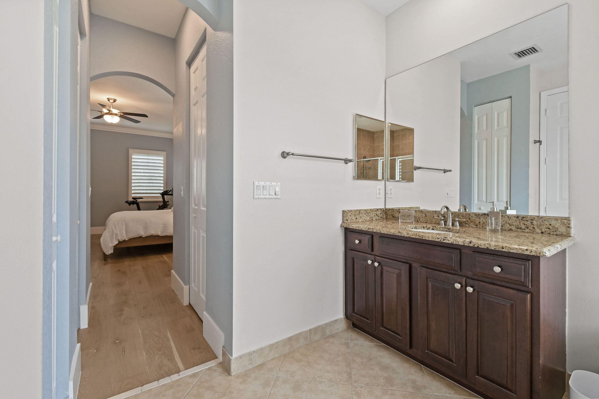 158 Ennis Lane Jupiter, FL 33458 - Photo 45 of 77 a en suite bathroom with a granite countertop sink and a mirror